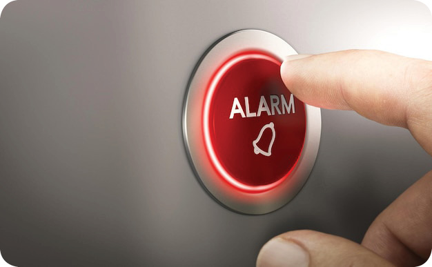 Photo finger pressing a red alarm button. warning concept. composite image between a hand photography and a 3d background.